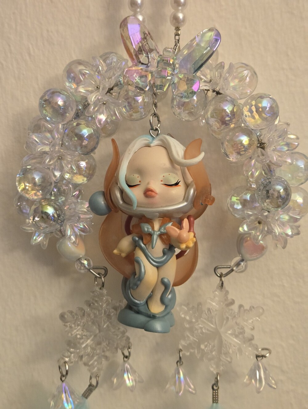 This handmade car ornament features a Pearl Beaded hanger and a Skullpandan
